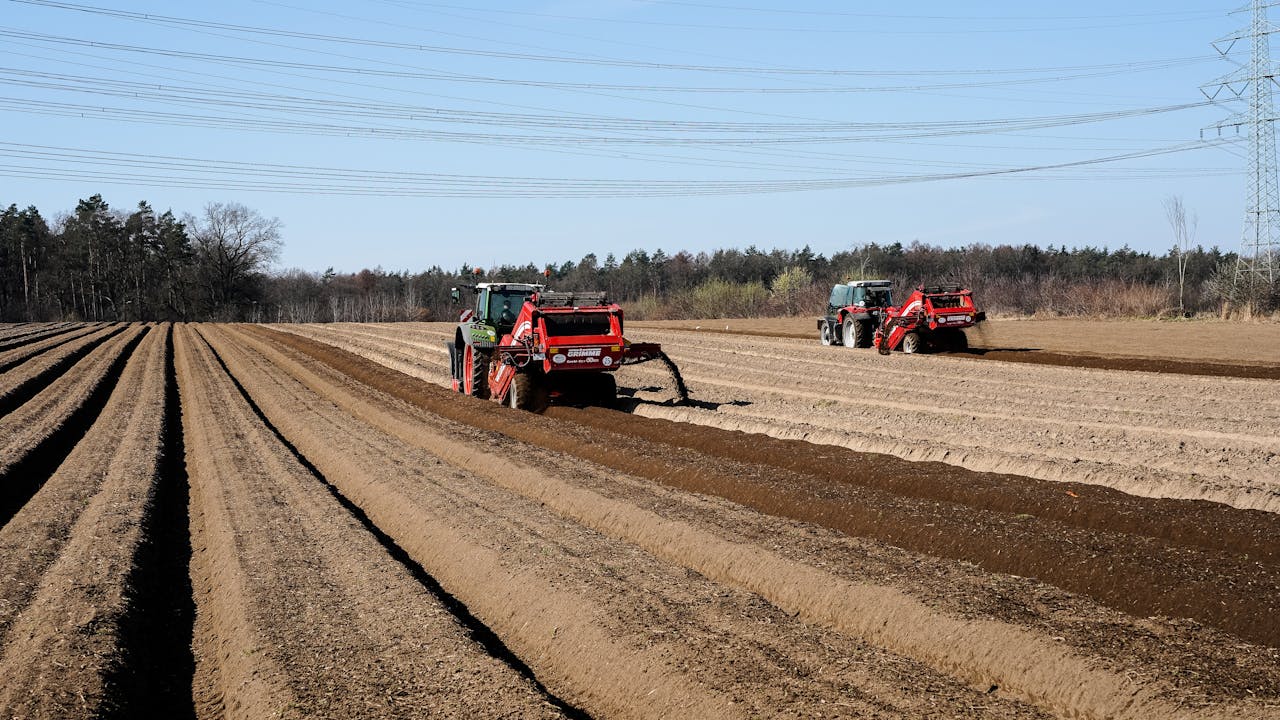 Tractors working on soil preparation in Wiershop, Germany during spring.